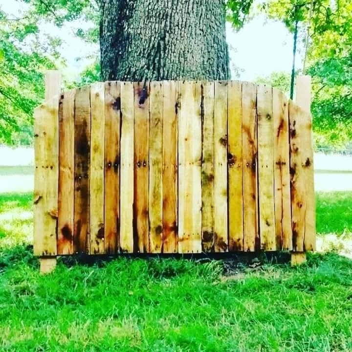 Custom oak headboard by Jet Construction showing natural wood grain and clean craftsmanship behind a made bed.