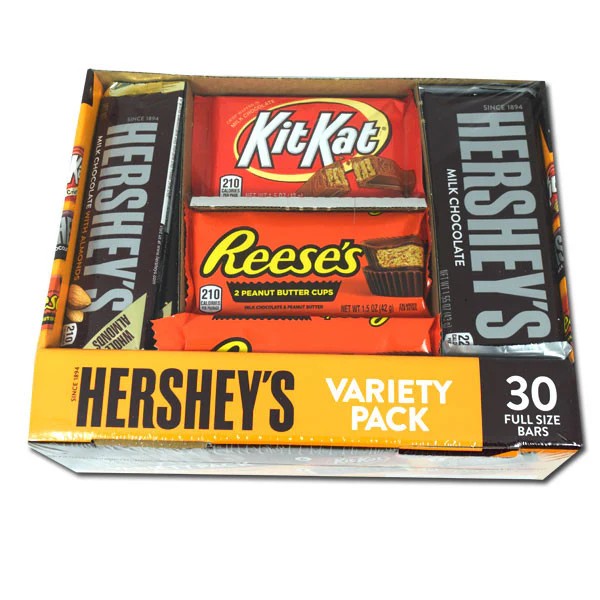 An assortment of Hershey's variety candy bars arranged in a retail display box on a clean surface.